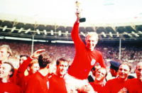 world-cup-final-1966-wembley-england-30th-july-1966-england-4-v-west-germany-2-englands-captain-bobby-moore-holds-aloft-the-jules-rimet-world-cup-trophy-as-he-sits-on-the-shoulders-of-his-teamma