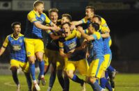 kings-lynn-goal-scorer-toby-hilliard-center-is-mobbed-by-team-mates_copy